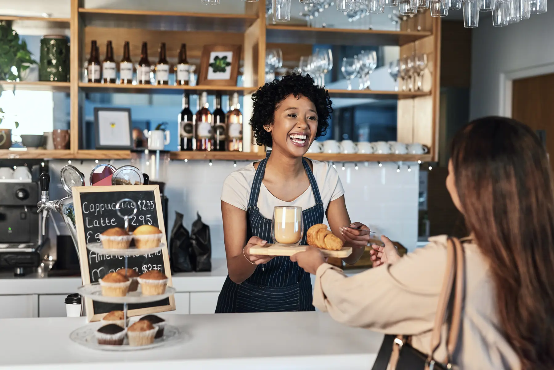 Cafe employee serving a customer