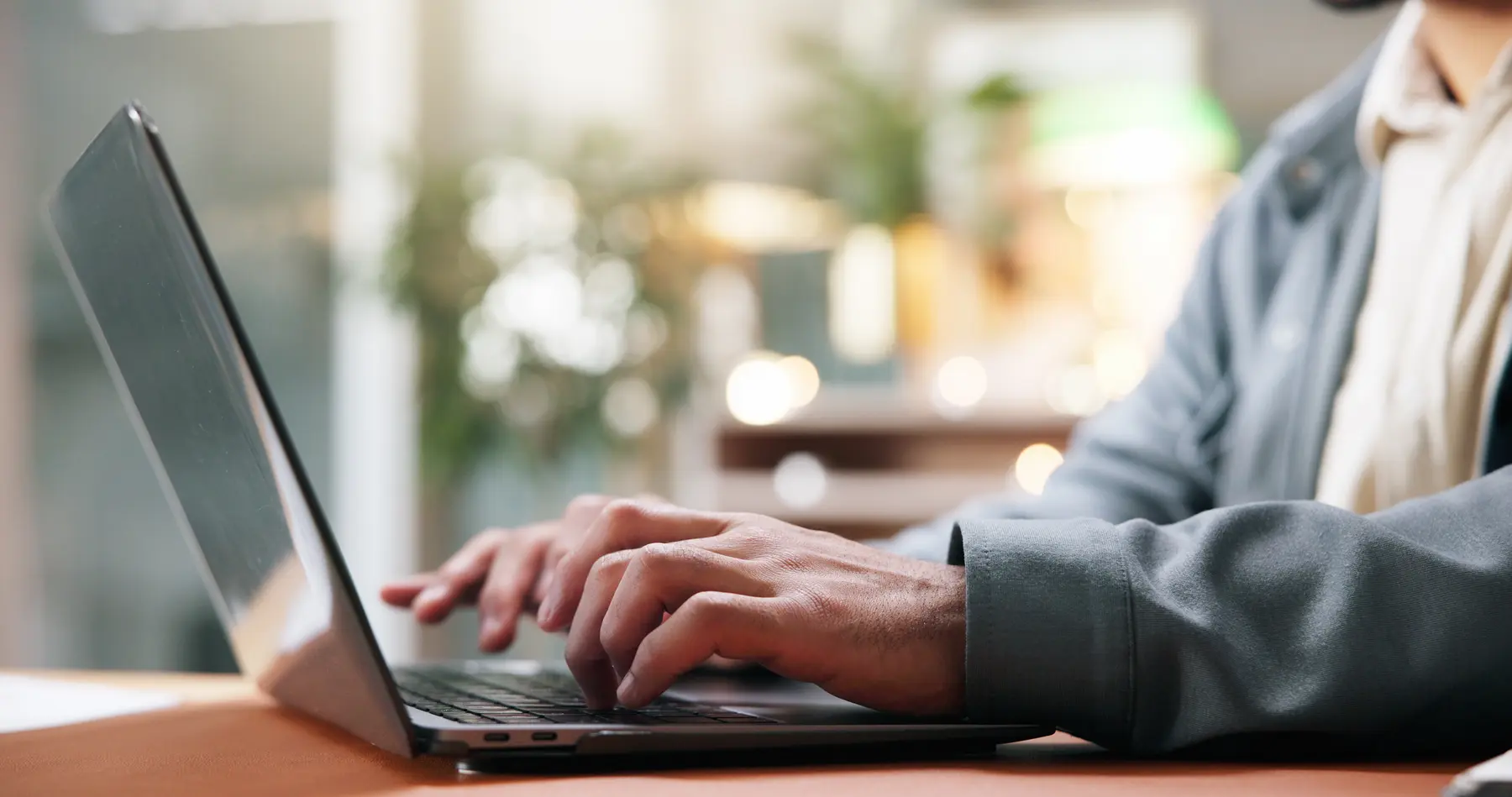 Person writing an article on a laptop