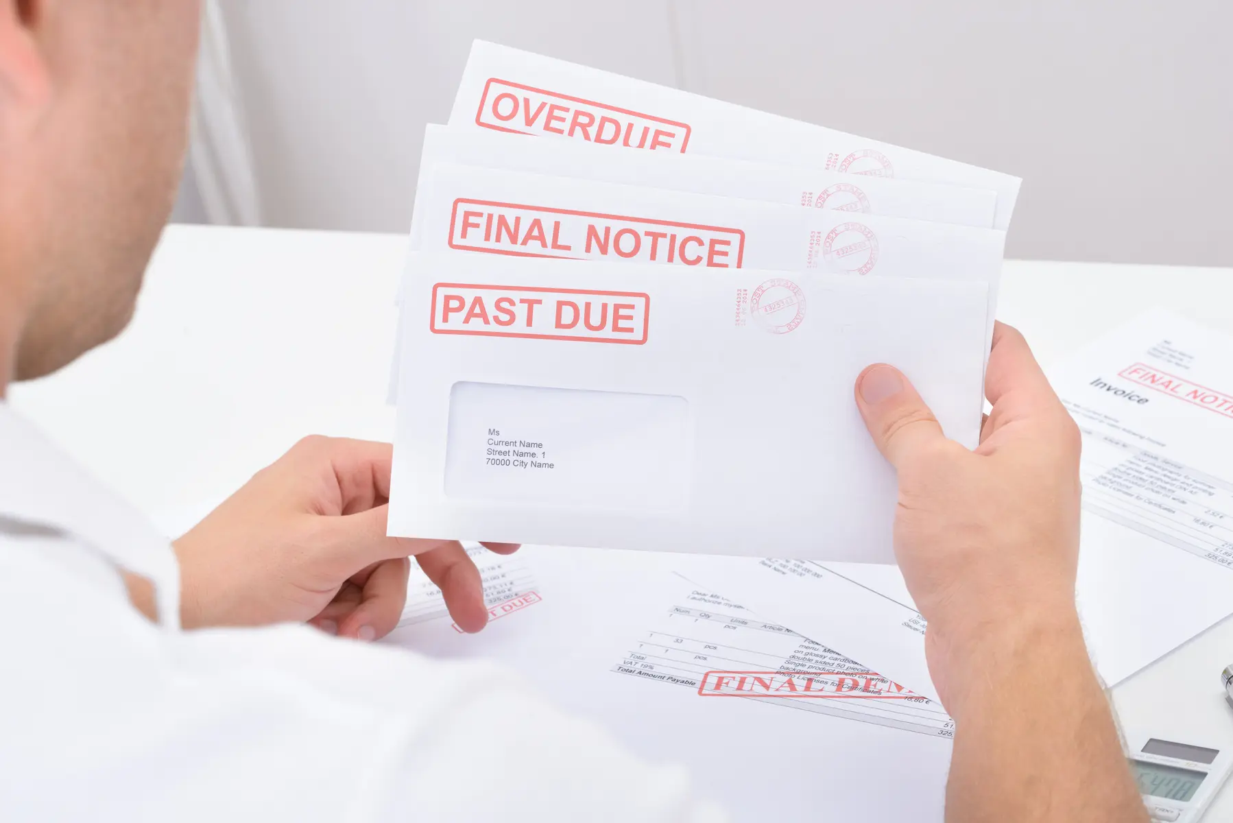 Person reviewing overdue tax notices