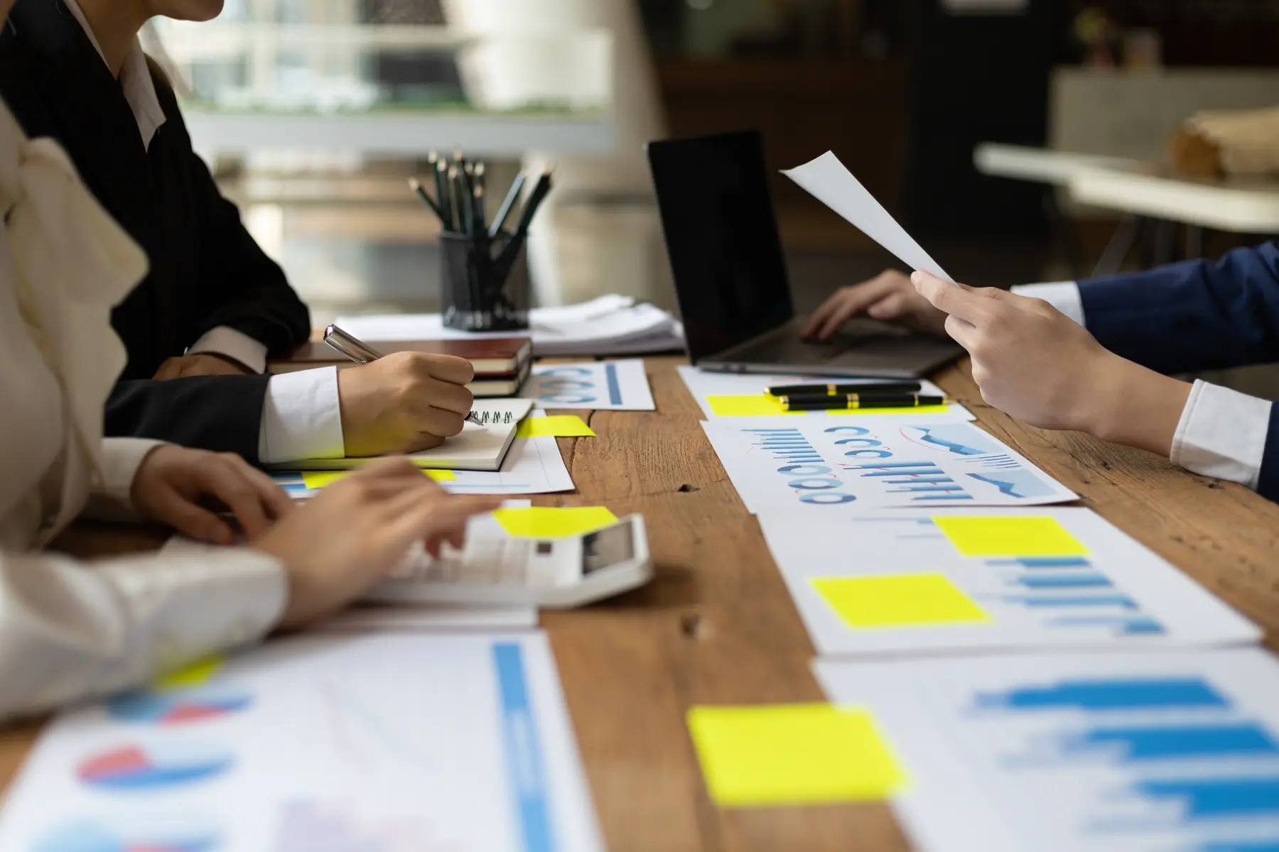 Finance professionals reviewing business performance reports