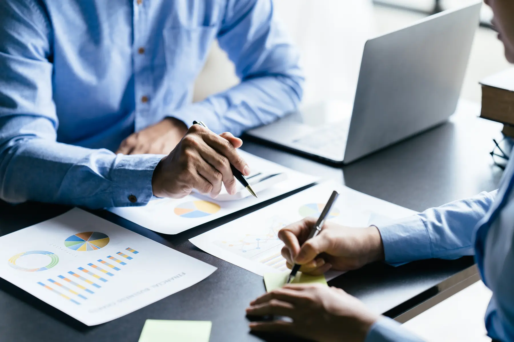 Corporate finance professionals reviewing reports