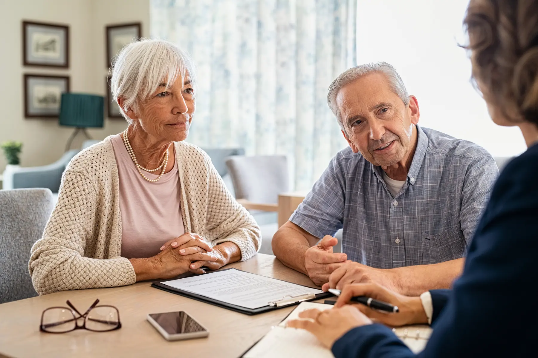 Older couple discussing investments with an adviser