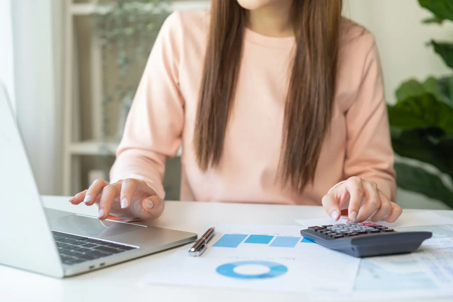 Professional calculating finances at a laptop