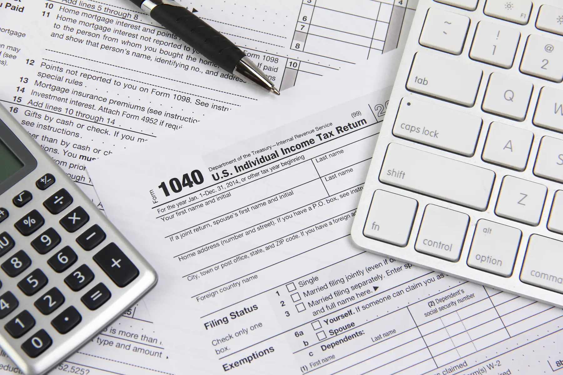 Tax forms, calculator, and computer keyboard